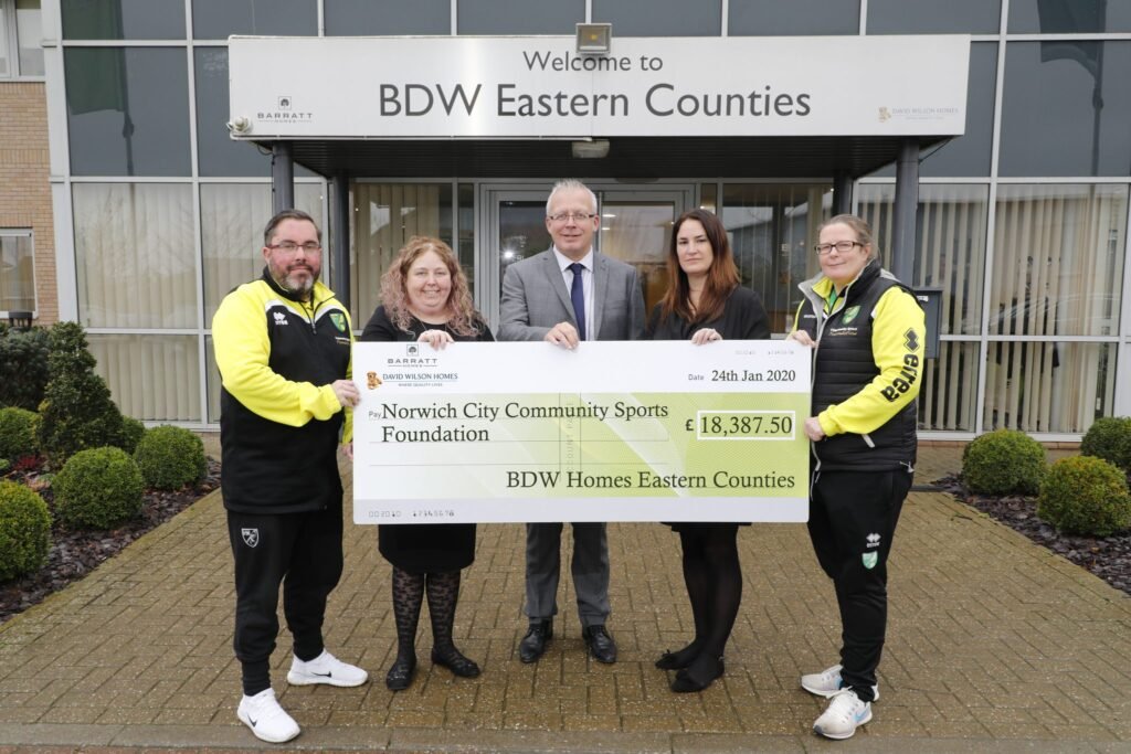 Kelly Ager, Mark Cotes and Kelly Braybrook present the cheque to Joe Harvey and Emma Fletcher